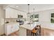 Modern kitchen featuring an island with seating, stainless steel appliances, and bright cabinets at 3422 Maplehurst Dr, Decatur, GA 30032