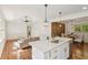 Open-concept living room with a kitchen island, recessed lighting, and wood floors, perfect for entertaining at 3422 Maplehurst Dr, Decatur, GA 30032