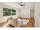 Cozy living room showcasing hardwood floors, decorative ceiling, and large windows offering outdoor views at 3422 Maplehurst Dr, Decatur, GA 30032