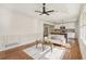 Bright living room featuring hardwood floors, paneled walls, and an open layout with a view into the kitchen at 3422 Maplehurst Dr, Decatur, GA 30032