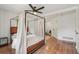 Stylish main bedroom with a canopy bed, hardwood floors, and a neutral color scheme at 3422 Maplehurst Dr, Decatur, GA 30032
