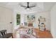 Home office featuring hardwood floors, bright windows, and a modern ceiling fan at 3422 Maplehurst Dr, Decatur, GA 30032