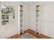 Spacious walk-in closet with hardwood floors, shelving, and a bright window at 3422 Maplehurst Dr, Decatur, GA 30032
