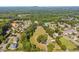 Aerial view of property with farmhouse nestled in a grove of mature trees at 3842 Ernest W Barrett Sw Pkwy, Marietta, GA 30064