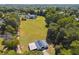 Aerial view of the property, including the home, barn, and surrounding land and trees, providing privacy at 3842 Ernest W Barrett Sw Pkwy, Marietta, GA 30064
