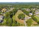 Aerial view of estate home nestled in a large wooded lot and green grass at 3842 Ernest W Barrett Sw Pkwy, Marietta, GA 30064