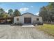 Large outdoor barn area for equipment or storage with a gated fence, attached shed, and gravel driveway at 3842 Ernest W Barrett Sw Pkwy, Marietta, GA 30064