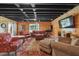 Basement living area with wood paneling, comfortable seating and large-screen TV at 3842 Ernest W Barrett Sw Pkwy, Marietta, GA 30064