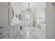Elegant bathroom with marble floors, dual vanities, a chandelier, and a freestanding tub at 3842 Ernest W Barrett Sw Pkwy, Marietta, GA 30064