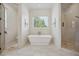 Clean, bright bathroom with a soaking tub, marble floors, and a glass-enclosed shower at 3842 Ernest W Barrett Sw Pkwy, Marietta, GA 30064