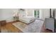 Bright bedroom with hardwood floors, light gray accents, and elegant french doors to the exterior at 3842 Ernest W Barrett Sw Pkwy, Marietta, GA 30064