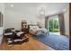 Primary bedroom features wood floors, neutral tones, a leather chair, and a large window at 3842 Ernest W Barrett Sw Pkwy, Marietta, GA 30064