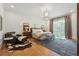 Bright bedroom featuring wood floors, neutral tones, a leather chair, and a large window at 3842 Ernest W Barrett Sw Pkwy, Marietta, GA 30064