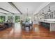Open-concept dining room boasts hardwood floors, beamed ceilings, and a large chandelier at 3842 Ernest W Barrett Sw Pkwy, Marietta, GA 30064
