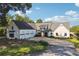 Paver driveway leads to a white modern farmhouse with black trim and three-car garage at 3842 Ernest W Barrett Sw Pkwy, Marietta, GA 30064