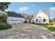 Expansive front yard with circular driveway, white farmhouse exterior, and three-car garage at 3842 Ernest W Barrett Sw Pkwy, Marietta, GA 30064