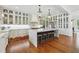 Elegant kitchen boasts a large island, custom cabinets, modern lighting, and hardwood floors at 3842 Ernest W Barrett Sw Pkwy, Marietta, GA 30064