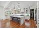 Open-concept kitchen with marble island, pendant lighting, stainless appliances, and hardwood floors at 3842 Ernest W Barrett Sw Pkwy, Marietta, GA 30064
