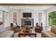 This living room includes a marble fireplace, hardwood floors and comfortable seating at 3842 Ernest W Barrett Sw Pkwy, Marietta, GA 30064