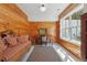 Cozy office with wood-paneled walls, a large window, and a rustic wooden desk at 3842 Ernest W Barrett Sw Pkwy, Marietta, GA 30064