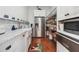 This walk-in pantry features marble counters, stainless refrigerator and wire shelving at 3842 Ernest W Barrett Sw Pkwy, Marietta, GA 30064
