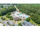 An aerial view of a community pool with a lazy river, slide, and other water features surrounded by green trees at 428 Redwood Trl, Canton, GA 30114