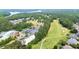 The aerial view showcases a meticulously maintained golf course, lake, and surrounding residential area at 428 Redwood Trl, Canton, GA 30114
