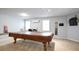 Finished basement featuring a pool table area with natural light from the windows at 428 Redwood Trl, Canton, GA 30114