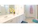 Bright bathroom features a double sink vanity with white cabinets and framed mirror at 428 Redwood Trl, Canton, GA 30114