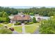 A detailed view of the clubhouse with stone accents, lush landscaping, and a glimpse of the community pool at 428 Redwood Trl, Canton, GA 30114