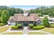 Beautiful clubhouse with stone accents and manicured landscaping at the entrance at 428 Redwood Trl, Canton, GA 30114