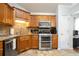 Well-lit kitchen features stainless steel appliances, granite countertops, and tile backsplash at 428 Redwood Trl, Canton, GA 30114