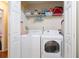 Convenient laundry area equipped with a washer, dryer, and storage shelves at 428 Redwood Trl, Canton, GA 30114