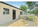 A newly constructed wooden deck with a black door against a white brick exterior wall offers outdoor living at 1261 Cliffwood Se Dr, Smyrna, GA 30080