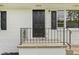 Close-up of the black front door framed by white brick and black shutters at 1261 Cliffwood Se Dr, Smyrna, GA 30080
