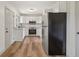 Galley kitchen features updated stainless steel appliances and bright white cabinets at 1261 Cliffwood Se Dr, Smyrna, GA 30080