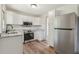 Modern kitchen with stainless steel appliances, light grey countertops, and updated cabinets at 1261 Cliffwood Se Dr, Smyrna, GA 30080