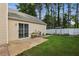 A fenced backyard features a well manicured lawn, patio and mature trees at 2657 Albion Farm Way, Duluth, GA 30097