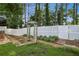 Landscaped backyard features a white fence, garden with stone walkway and arbor at 2657 Albion Farm Way, Duluth, GA 30097