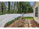 Backyard with manicured garden beds, privacy fence, and direct access to the home at 2657 Albion Farm Way, Duluth, GA 30097