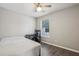 A bedroom features a ceiling fan, window and desk at 2657 Albion Farm Way, Duluth, GA 30097