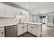 Updated kitchen with white cabinets, stainless steel appliances, and a view to the backyard at 2657 Albion Farm Way, Duluth, GA 30097