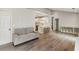 Open-concept living room with hardwood floors, high ceilings, and a view into the kitchen at 2657 Albion Farm Way, Duluth, GA 30097