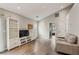 Bright living room featuring hardwood floors, a vaulted ceiling, and access to other rooms at 2657 Albion Farm Way, Duluth, GA 30097