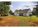 Spacious backyard with a white home exterior, large lawn, and an extended carport at 3508 Cox Cemetery Rd, Social Circle, GA 30025