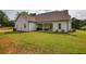 Expansive backyard featuring lush green lawn and a covered patio ideal for outdoor entertaining at 3508 Cox Cemetery Rd, Social Circle, GA 30025