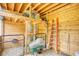 Interior view of barn featuring wood paneling, storage, and ample space for hay and equipment at 3508 Cox Cemetery Rd, Social Circle, GA 30025