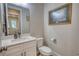 Half bath featuring vanity, sink, toilet and wall art at 3508 Cox Cemetery Rd, Social Circle, GA 30025