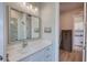 Bathroom featuring vanity with view into connecting bathroom and laundry room at 3508 Cox Cemetery Rd, Social Circle, GA 30025