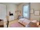 Charming bedroom featuring a bed with pink accents, soft lighting, and inviting decor at 3508 Cox Cemetery Rd, Social Circle, GA 30025